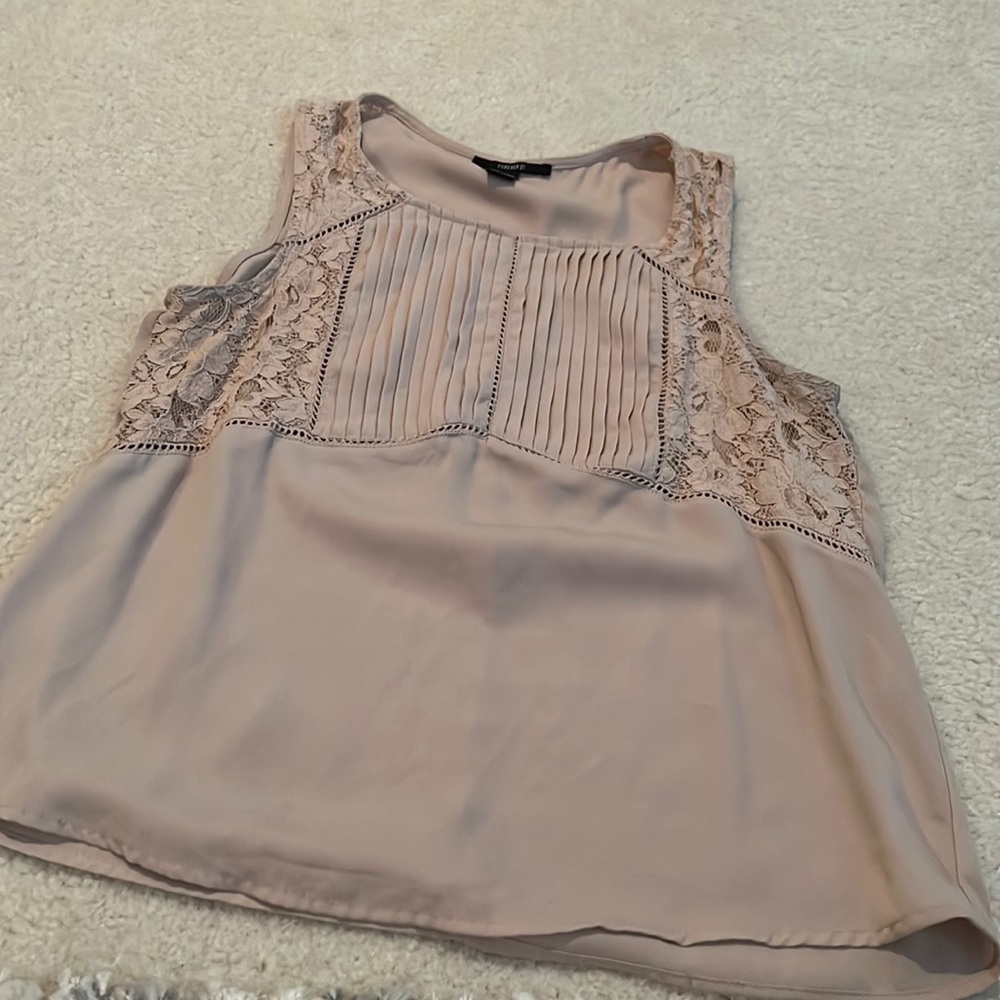 Tan colored sleeveless blouse